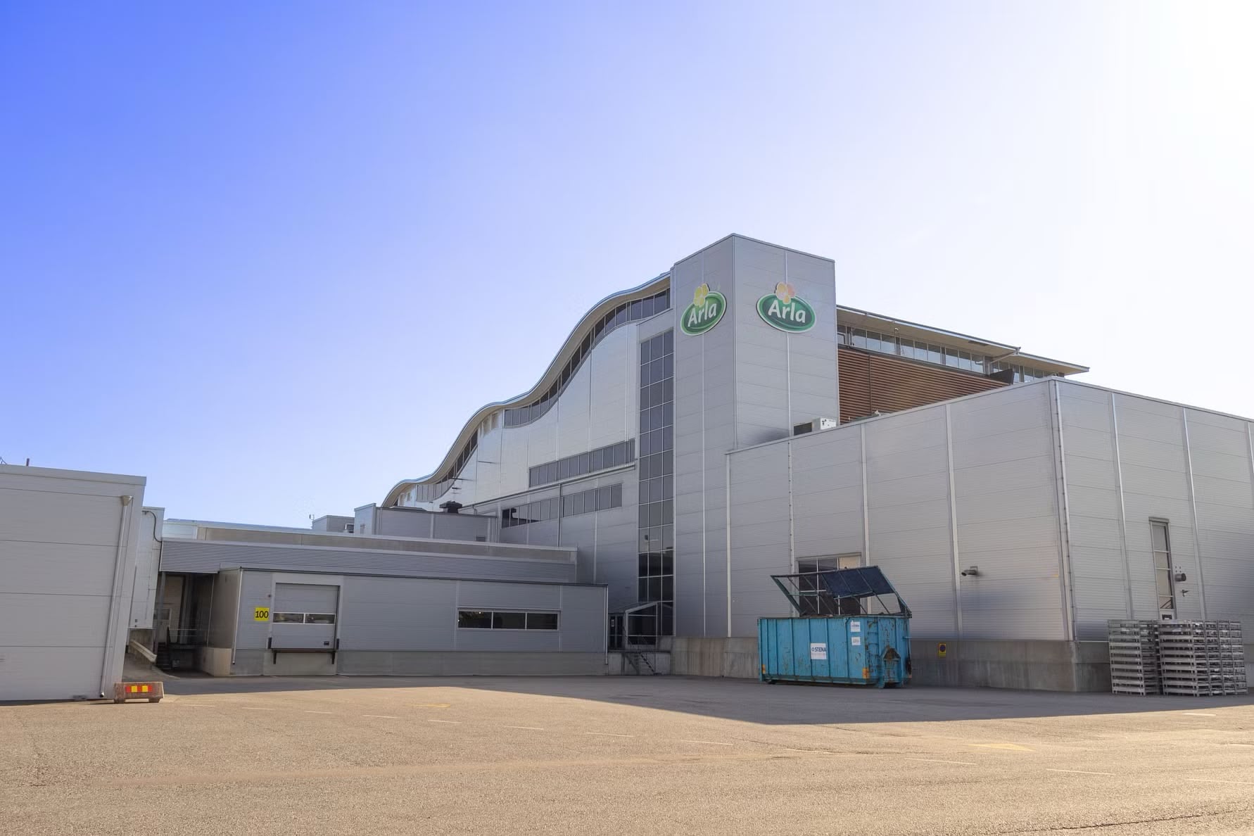 Farmer feeding cows in a barn